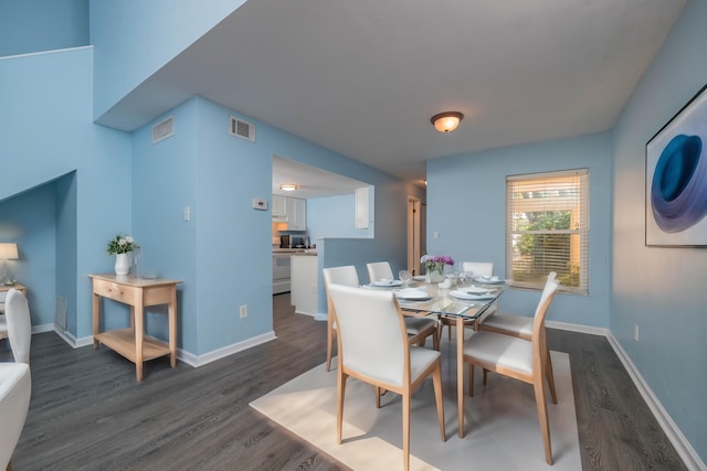 dining area with dark hardwood / wood-style floors