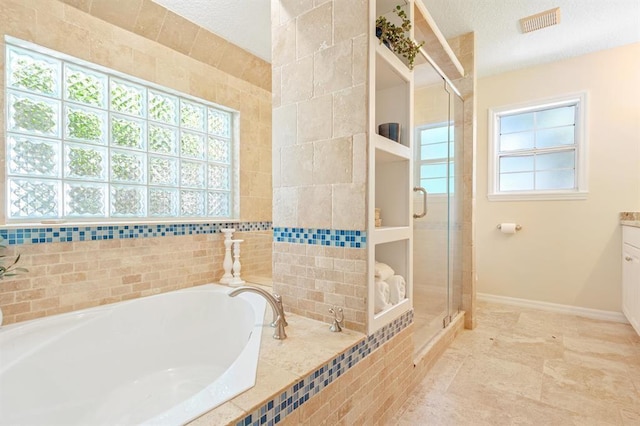 bathroom with shower with separate bathtub, vanity, and a textured ceiling