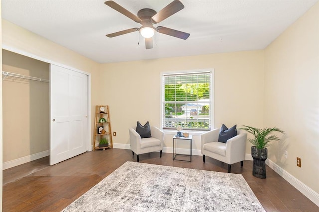 living area with dark hardwood / wood-style floors and ceiling fan