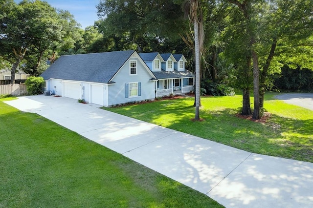 new england style home featuring a garage and a front yard