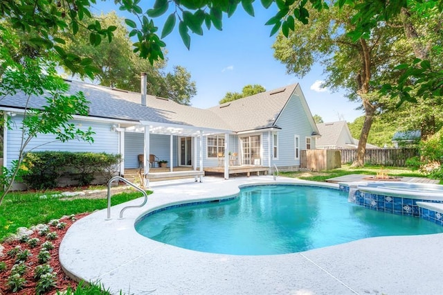 back of house featuring a pool with hot tub and a patio