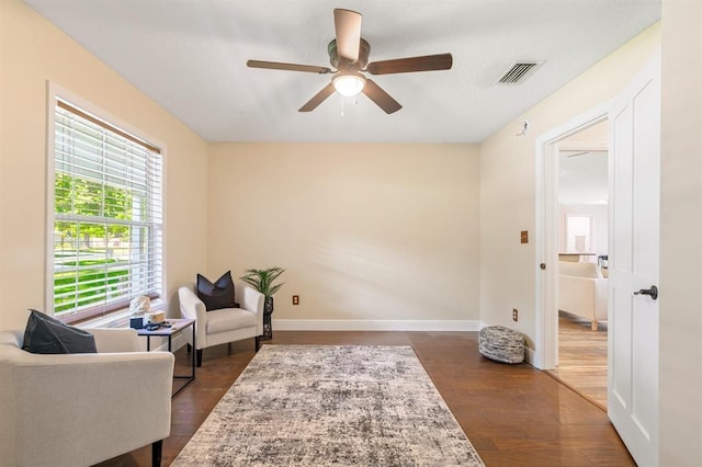 sitting room with dark hardwood / wood-style floors and ceiling fan