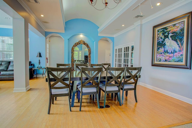 20102 Harbour Vista Cir, Saint Augustine, FL 32080 - dining space with arched walkways, light wood-style floors, crown molding, and recessed lighting