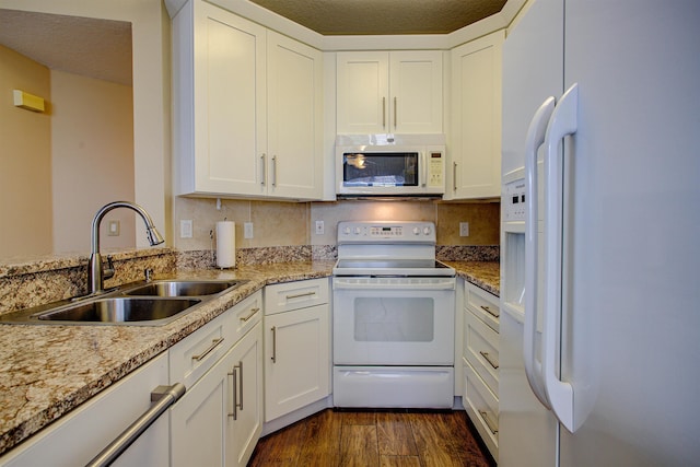 20102 Harbour Vista Cir, Saint Augustine, FL 32080 - kitchen with white appliances, dark wood-style floors, white cabinets, and light stone counters