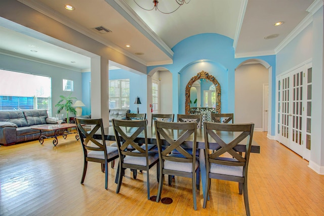 20102 Harbour Vista Cir, Saint Augustine, FL 32080 - dining area with arched walkways, light wood-style flooring, lofted ceiling, ornamental molding, and recessed lighting
