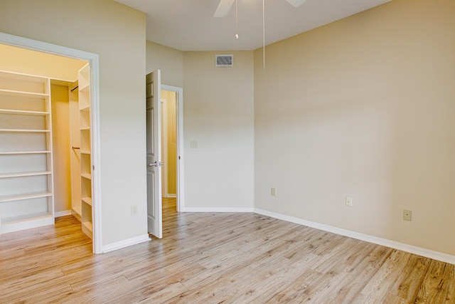 20102 Harbour Vista Cir, Saint Augustine, FL 32080 - unfurnished bedroom featuring wood finished floors, a spacious closet, and a ceiling fan