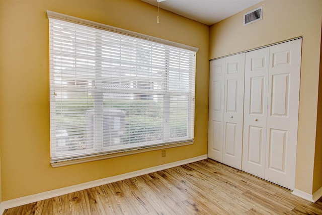 20102 Harbour Vista Cir, Saint Augustine, FL 32080 - unfurnished bedroom with multiple windows, a closet, and wood finished floors