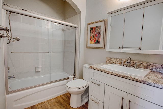 20102 Harbour Vista Cir, Saint Augustine, FL 32080 - bathroom featuring vanity, bath / shower combo with glass door, and wood finished floors