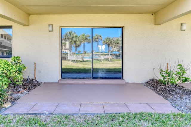 8550 S A1A # 331, Saint Augustine, FL 32080 - view of exterior entry with stucco siding and a patio area