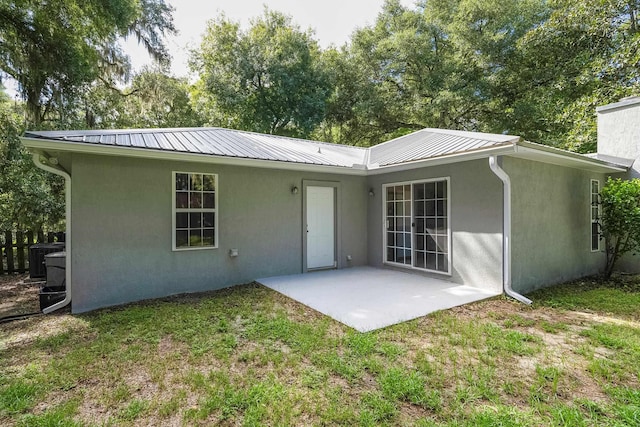 back of property featuring a patio area and a yard