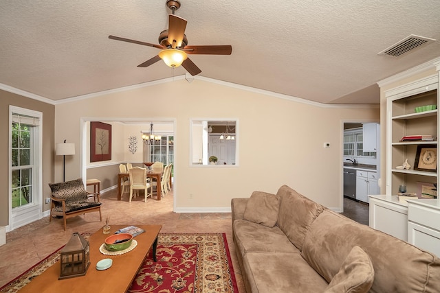 tiled living room featuring a textured ceiling, ceiling fan with notable chandelier, vaulted ceiling, and crown molding