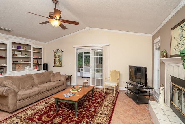 tiled living room featuring a textured ceiling, a tile fireplace, ceiling fan, and lofted ceiling