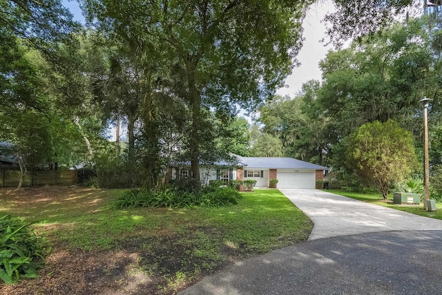 ranch-style house featuring a garage and a front lawn