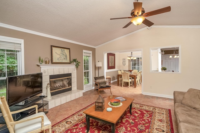 tiled living room with a tiled fireplace, lofted ceiling, and ornamental molding