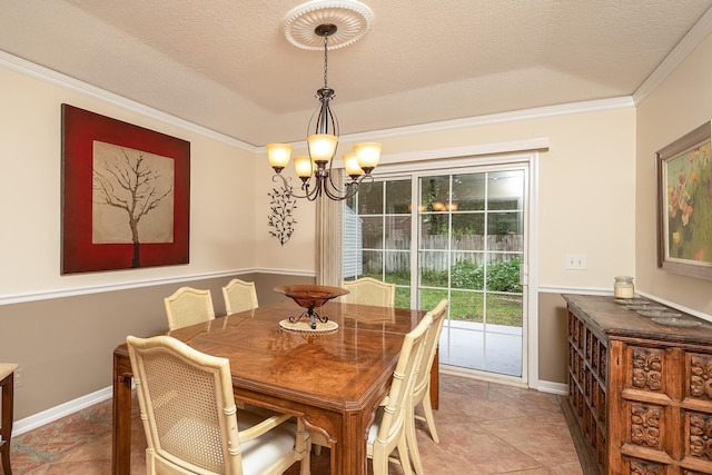 dining space with tile patterned floors, a chandelier, a textured ceiling, and ornamental molding