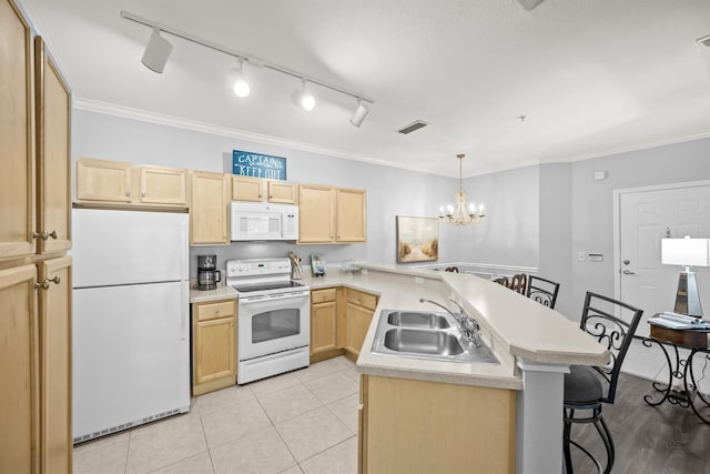 225 Old Village Center Cir Unit 4308, Saint Augustine, FL 32084 - kitchen featuring white appliances, light brown cabinetry, a peninsula, a kitchen bar, and a chandelier