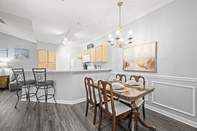 225 Old Village Center Cir Unit 4308, Saint Augustine, FL 32084 - dining room featuring dark wood-type flooring, a chandelier, rail lighting, ornamental molding, and wainscoting