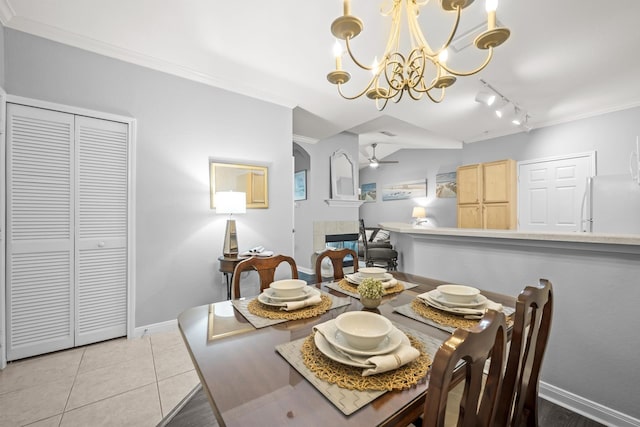 225 Old Village Center Cir Unit 4308, Saint Augustine, FL 32084 - dining space featuring track lighting, a chandelier, ornamental molding, a tile fireplace, and light tile patterned floors