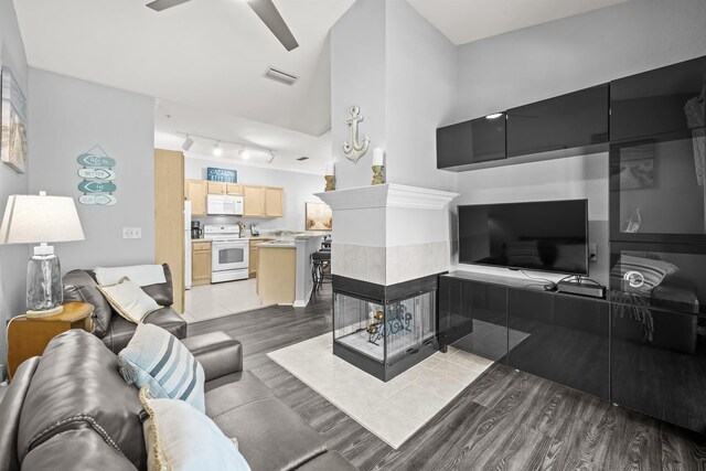 225 Old Village Center Cir Unit 4308, Saint Augustine, FL 32084 - living area featuring light wood finished floors, a tile fireplace, rail lighting, and ceiling fan
