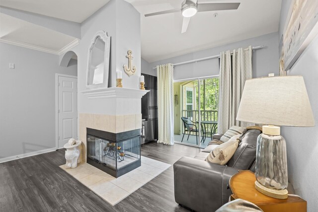 225 Old Village Center Cir Unit 4308, Saint Augustine, FL 32084 - living area featuring a tiled fireplace, ceiling fan, wood finished floors, lofted ceiling, and arched walkways