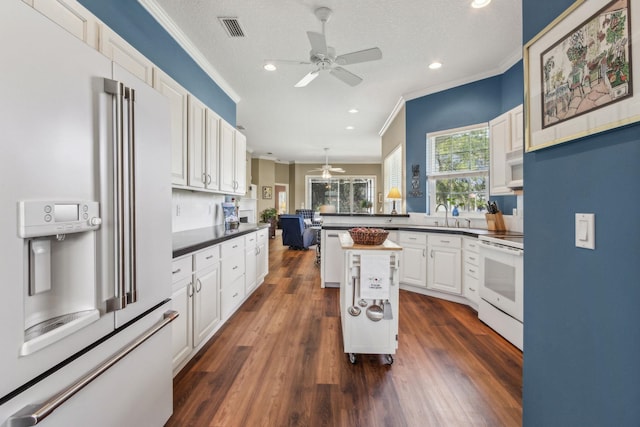 303 S Ocean Trace Rd, Saint Augustine, FL 32080 - kitchen with white appliances, ceiling fan, ornamental molding, white cabinetry, and recessed lighting