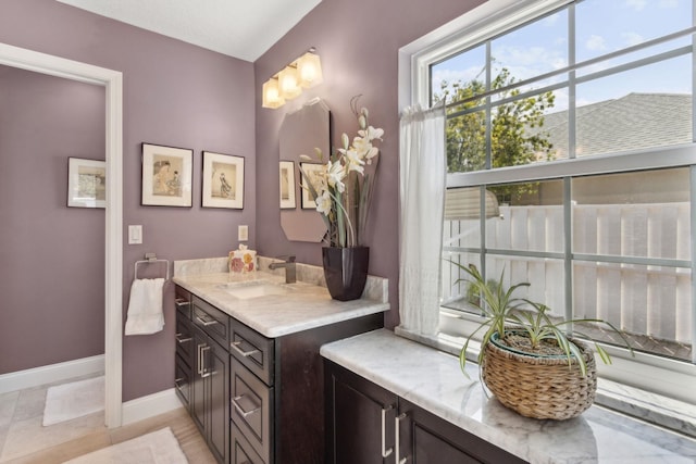 303 S Ocean Trace Rd, Saint Augustine, FL 32080 - bathroom featuring healthy amount of natural light, baseboards, and vanity