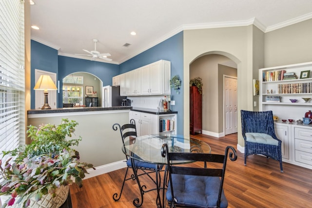 303 S Ocean Trace Rd, Saint Augustine, FL 32080 - dining space with arched walkways, wood finished floors, ceiling fan, ornamental molding, and recessed lighting