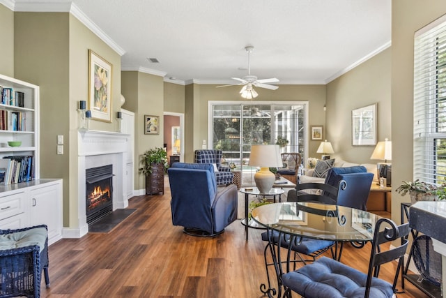 303 S Ocean Trace Rd, Saint Augustine, FL 32080 - living room with ceiling fan, wood finished floors, a fireplace with flush hearth, ornamental molding, and baseboards