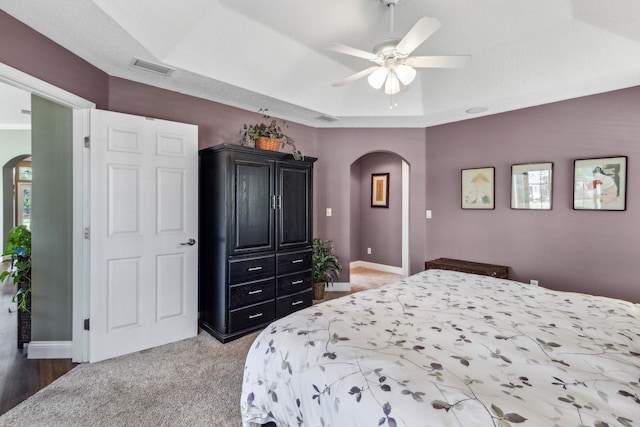 303 S Ocean Trace Rd, Saint Augustine, FL 32080 - bedroom with arched walkways, baseboards, light carpet, and ceiling fan
