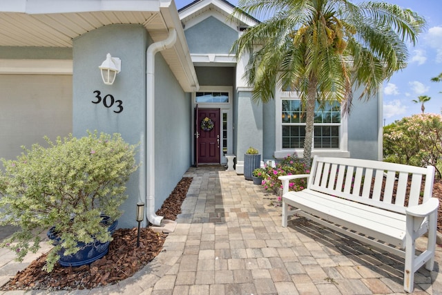 303 S Ocean Trace Rd, Saint Augustine, FL 32080 - doorway to property featuring stucco siding
