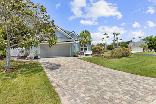 303 S Ocean Trace Rd, Saint Augustine, FL 32080 - view of front of property featuring stucco siding, decorative driveway, and a garage