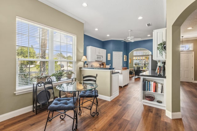 303 S Ocean Trace Rd, Saint Augustine, FL 32080 - dining area with arched walkways, crown molding, plenty of natural light, recessed lighting, and baseboards