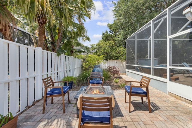 303 S Ocean Trace Rd, Saint Augustine, FL 32080 - view of patio / terrace featuring an outdoor fire pit, a fenced backyard, and a lanai