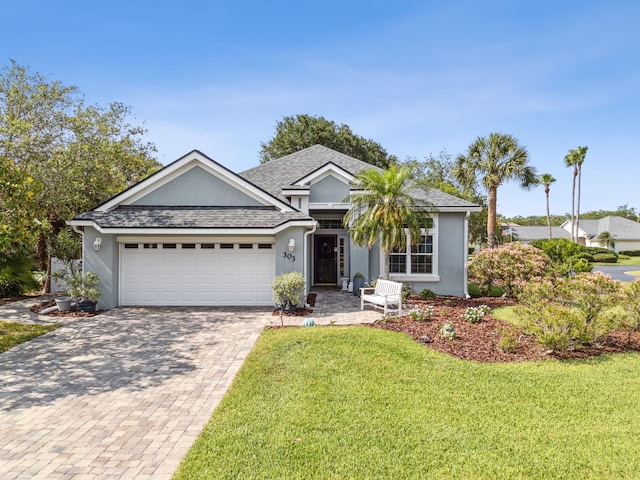 303 S Ocean Trace Rd, Saint Augustine, FL 32080 - ranch-style home with a garage, decorative driveway, a front lawn, stucco siding, and a shingled roof