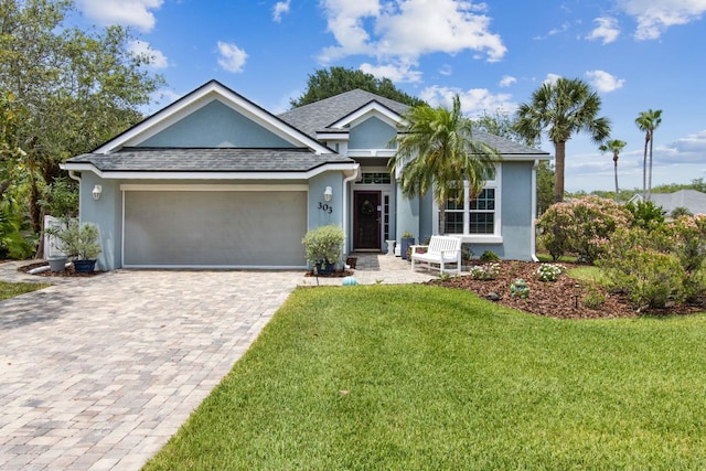 303 S Ocean Trace Rd, Saint Augustine, FL 32080 - ranch-style house with stucco siding, a garage, decorative driveway, a front lawn, and a shingled roof