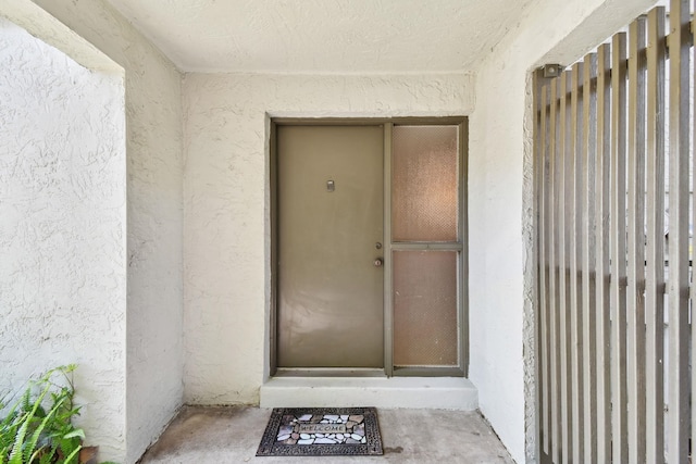 3 Tarragona Ct, Saint Augustine, FL 32086 - doorway to property with stucco siding