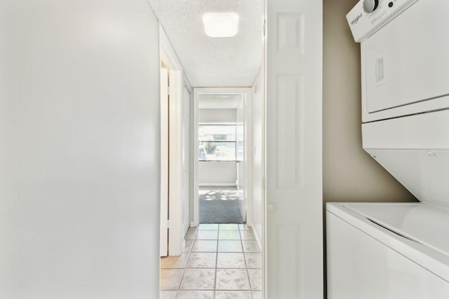 3 Tarragona Ct, Saint Augustine, FL 32086 - laundry room with estacked washer and dryer, light tile patterned flooring, baseboards, and a textured ceiling