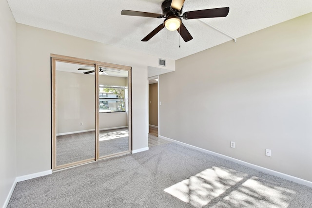 3 Tarragona Ct, Saint Augustine, FL 32086 - unfurnished bedroom featuring a textured ceiling, a closet, baseboards, carpet, and ceiling fan