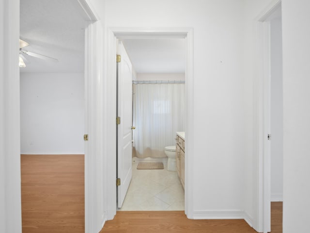 hallway with light hardwood / wood-style floors