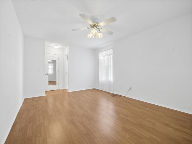 spare room with light hardwood / wood-style flooring and ceiling fan