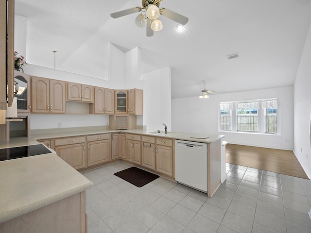 kitchen with light tile patterned floors, sink, dishwasher, light brown cabinetry, and kitchen peninsula