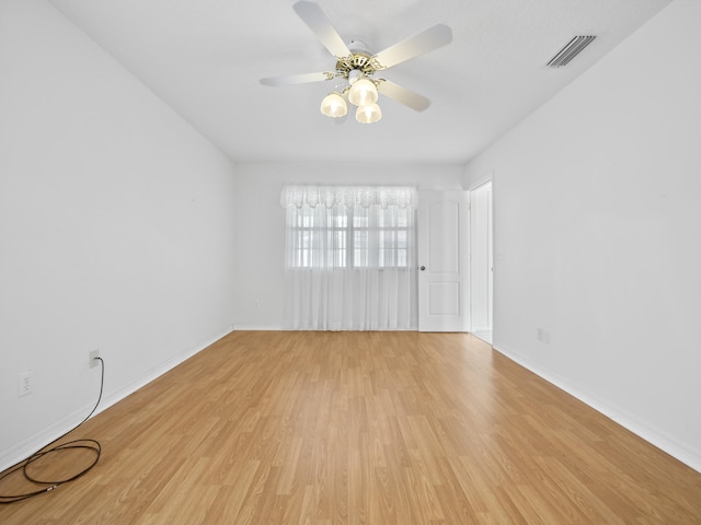 empty room featuring ceiling fan and light hardwood / wood-style floors