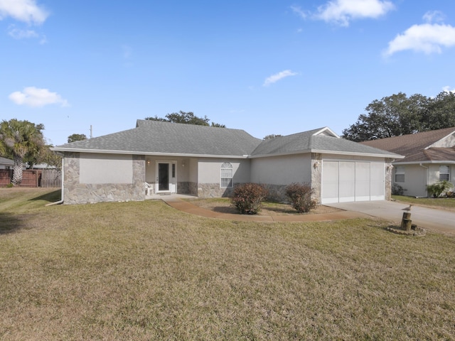 single story home with a garage and a front lawn