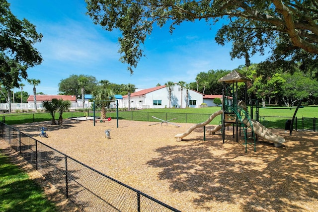 view of home's community with a playground and a yard