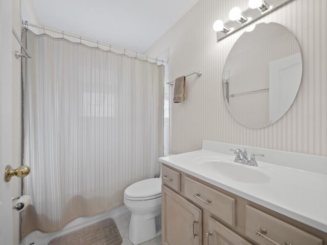 full bathroom featuring vanity, shower / tub combo, and toilet