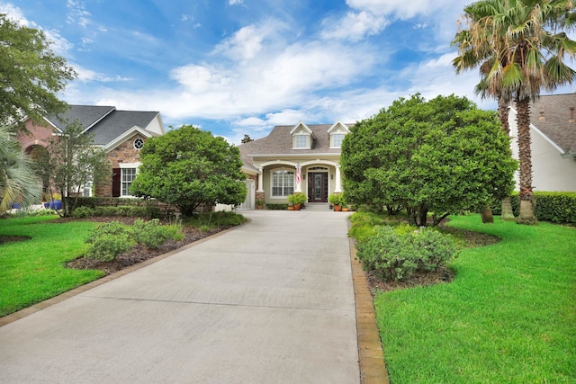 159 La Mesa Dr, Saint Augustine, FL 32095 - view of front of property featuring a front yard, driveway, and stone siding