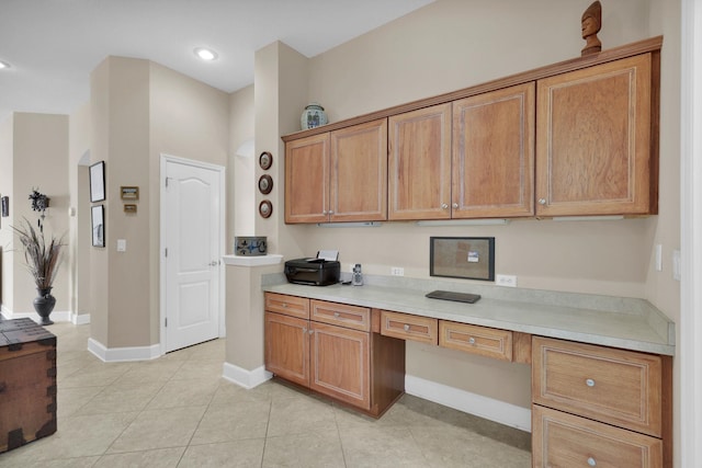 159 La Mesa Dr, Saint Augustine, FL 32095 - kitchen with light countertops, built in study area, brown cabinets, light tile patterned flooring, and recessed lighting