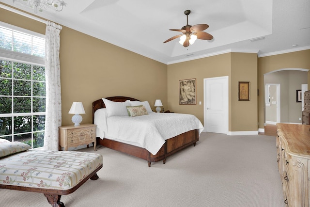 159 La Mesa Dr, Saint Augustine, FL 32095 - bedroom featuring arched walkways, light colored carpet, ceiling fan, crown molding, and a raised ceiling