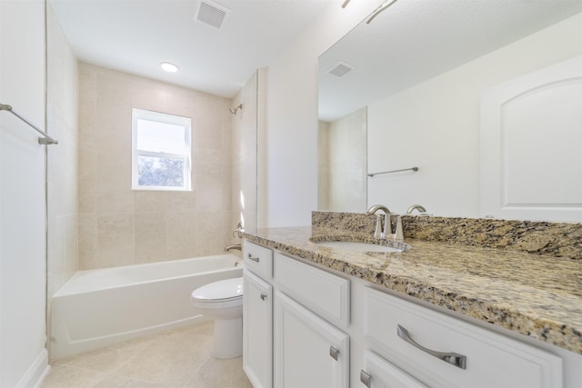 full bathroom with toilet, vanity, tile patterned flooring, and tiled shower / bath