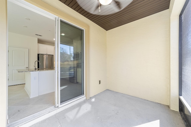 balcony with ceiling fan and sink